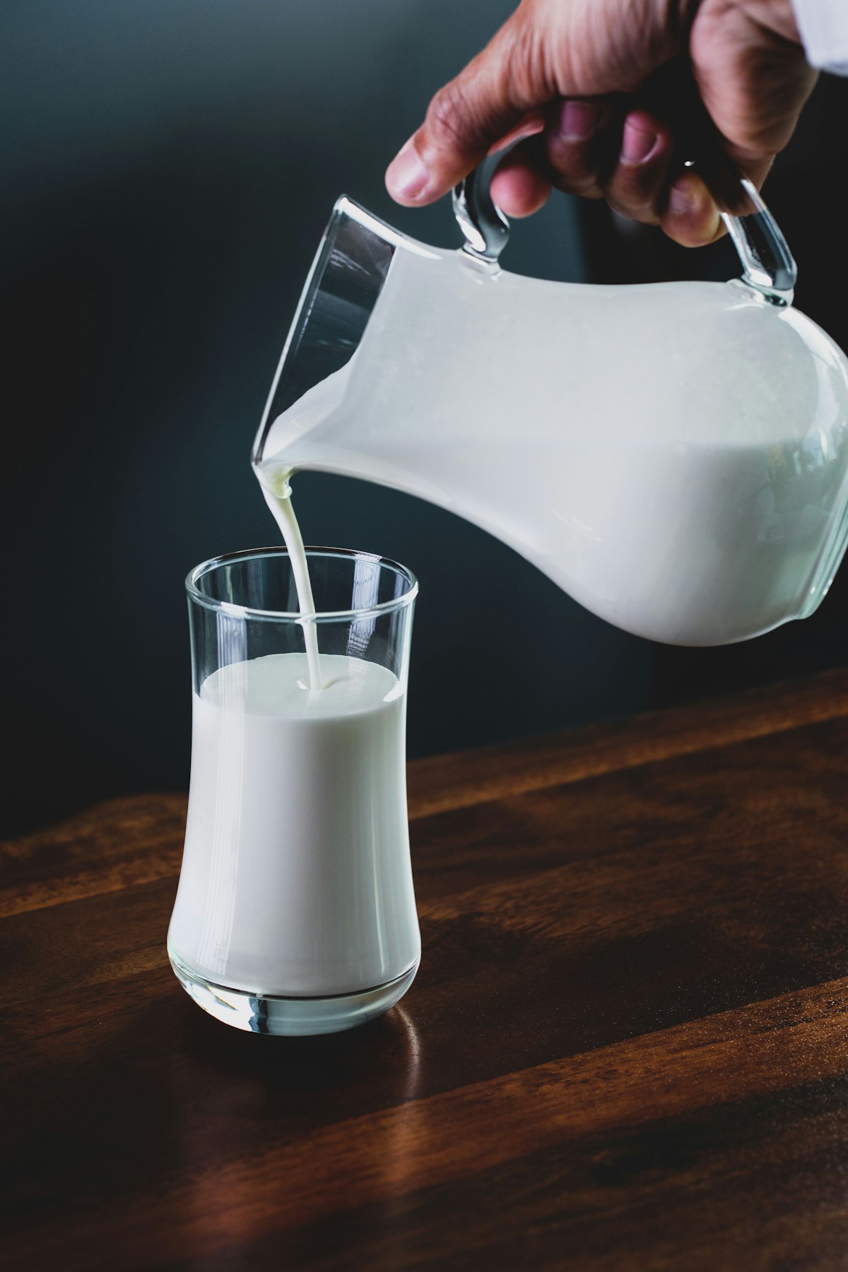 White coconut milk pouring into a glass