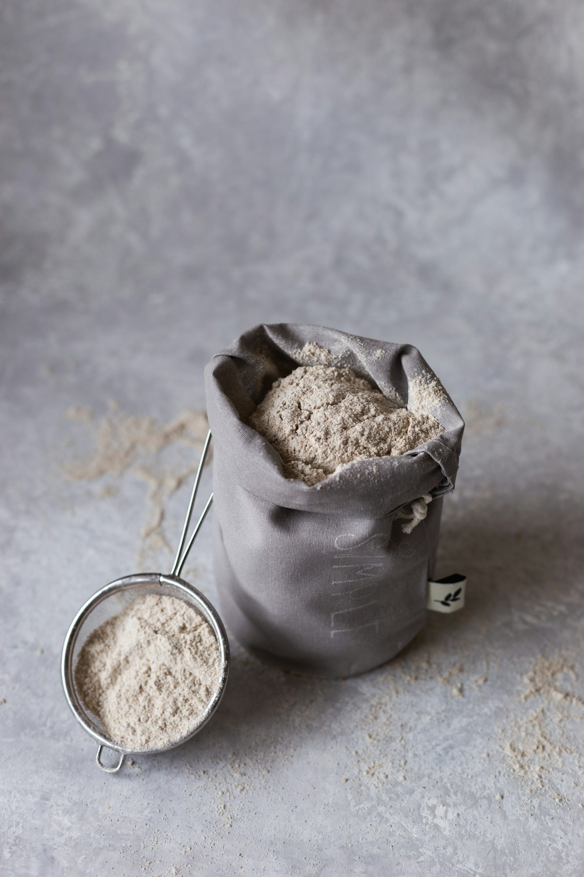 Unrefined sugar powder in a sack with sieve